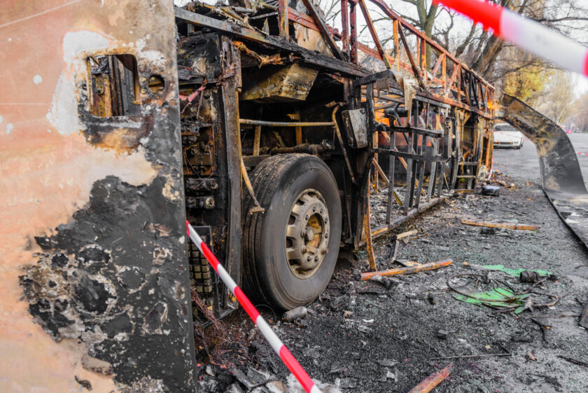 Image of bus accident lawyers examining documents and a bus crash site map on a table, showcasing their role in investigating and litigating bus accident cases.