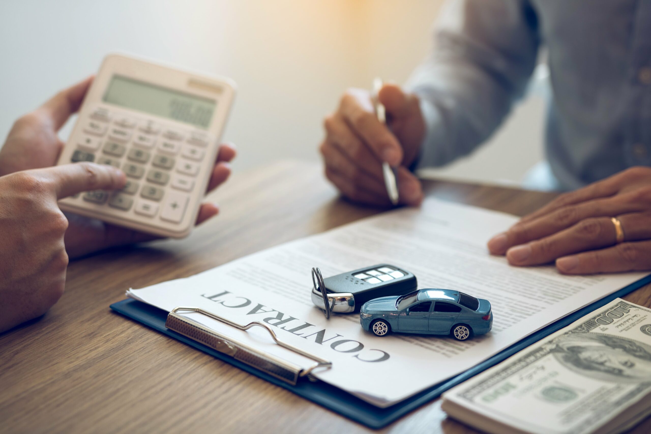 Understanding Car Accident Lawyer Costs: What You Need to Know" - An image illustrating a person reviewing legal documents and financial papers, symbolizing the need for understanding the costs associated with hiring a car accident lawyer.